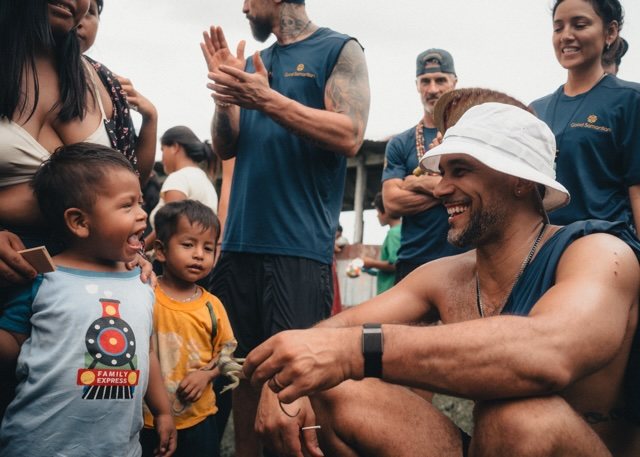 Small children laughing with smiling team members