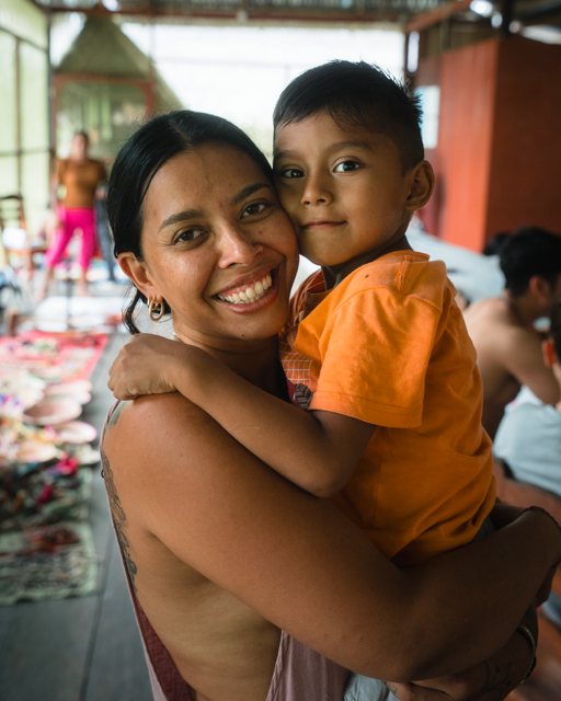 A smiling mother holding her young son