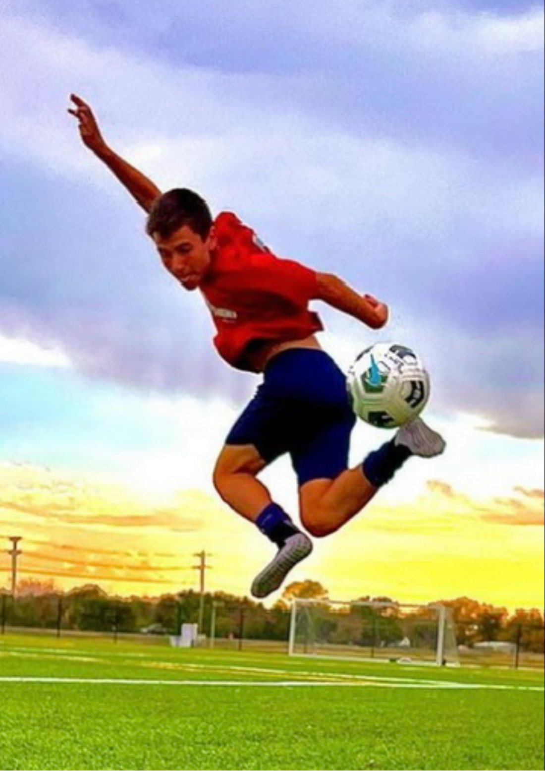 Founder Easton Brooks mid-air, striking a soccer ball on a turf field at sunset